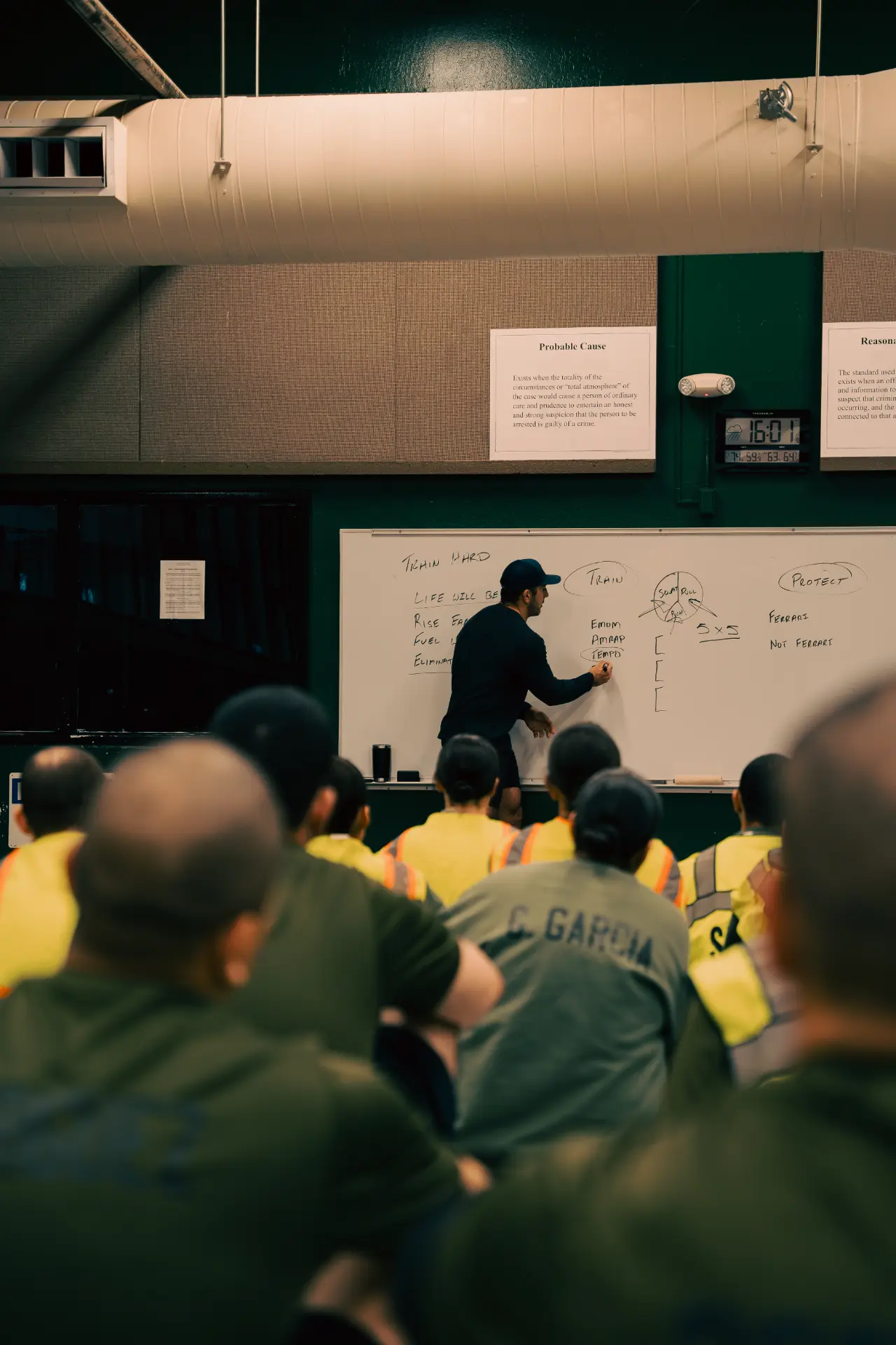 Jason Khalipa teaching a room of first responders at a whiteboard